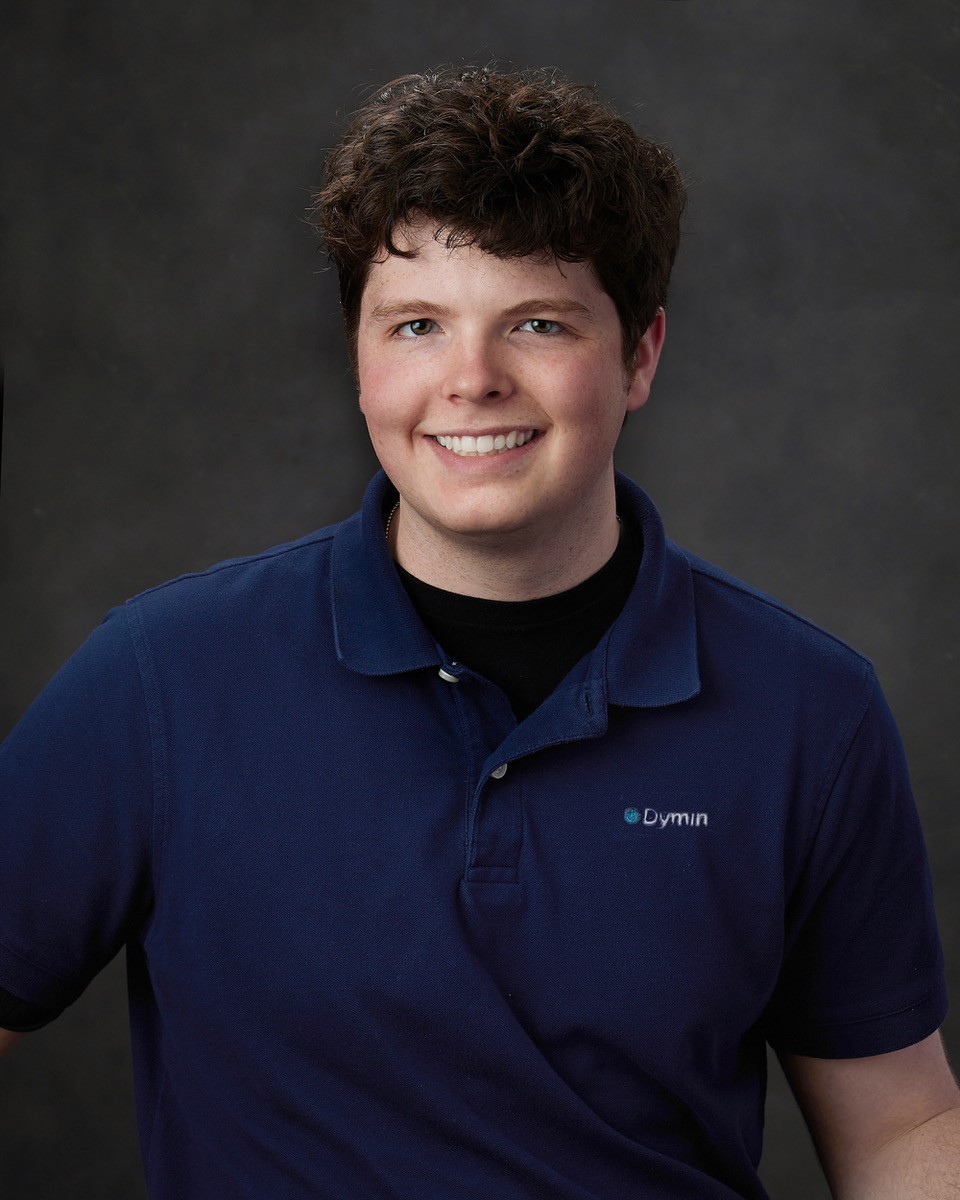 a young man in a blue shirt smiling